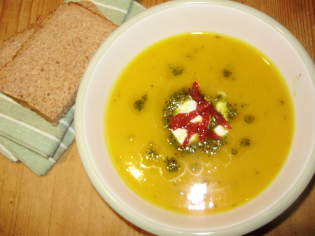 9. Sunshine soup served garnished with creme fraiche, basil pesto oil & semi-dehydrated Rosada