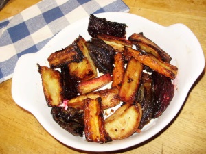 Roasted winter root vegetables with herb oil - ready to serve.