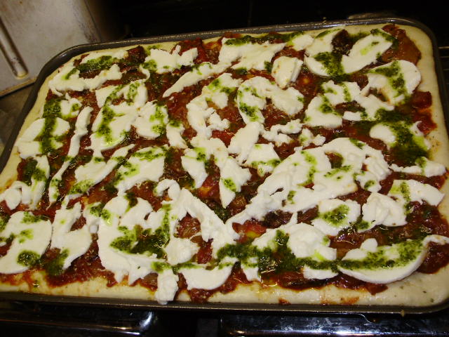 15d. Top with mozzarella, drizzle with pesto oil, cook 220 deg.C for 15-20mins until golden brown