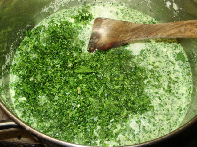 6. Stirring the chopped watercress or spinach into the simmering stock & milk mixture